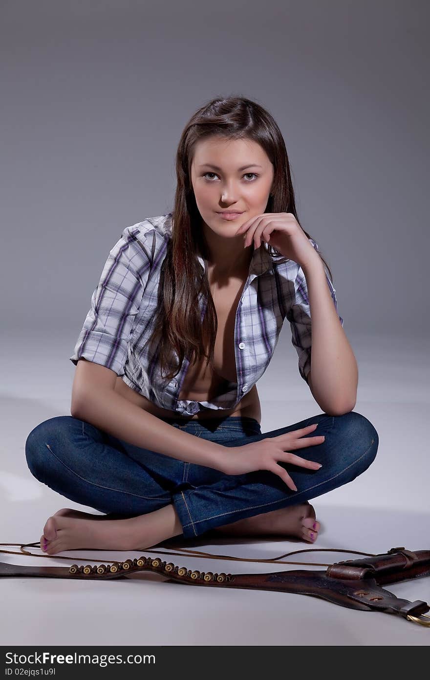 Young barefoot beautiful woman in checked shirt. Young barefoot beautiful woman in checked shirt