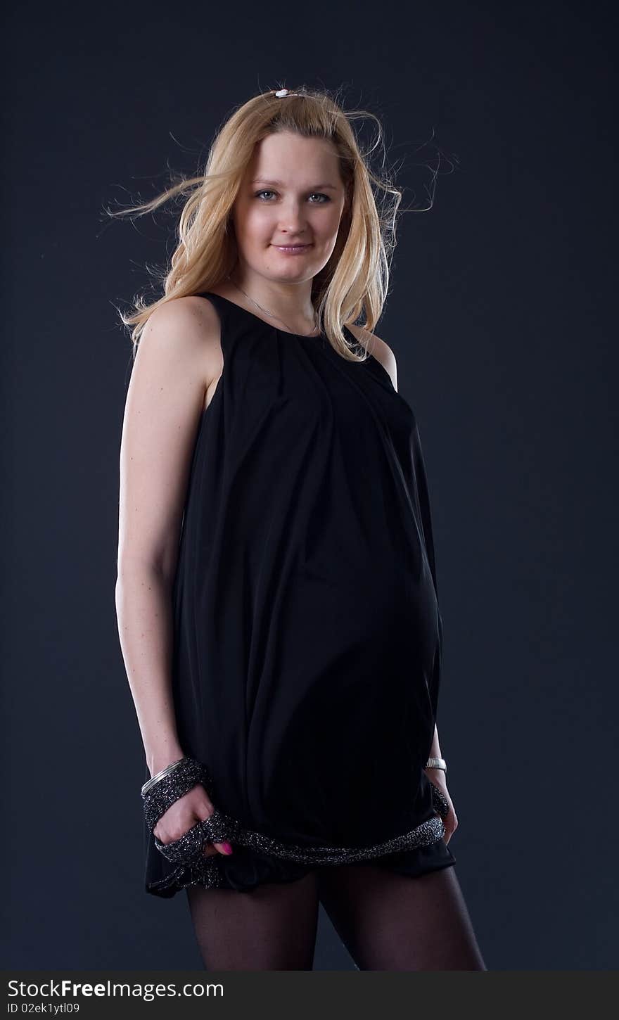 Blondy woman expecting a baby/black background. Blondy woman expecting a baby/black background