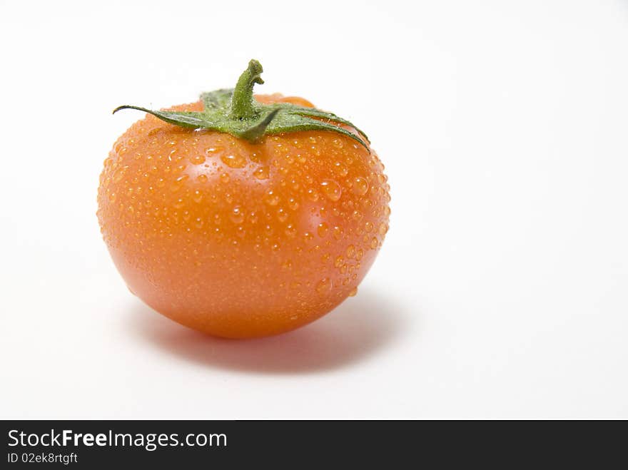 The fresh tomato on the white background