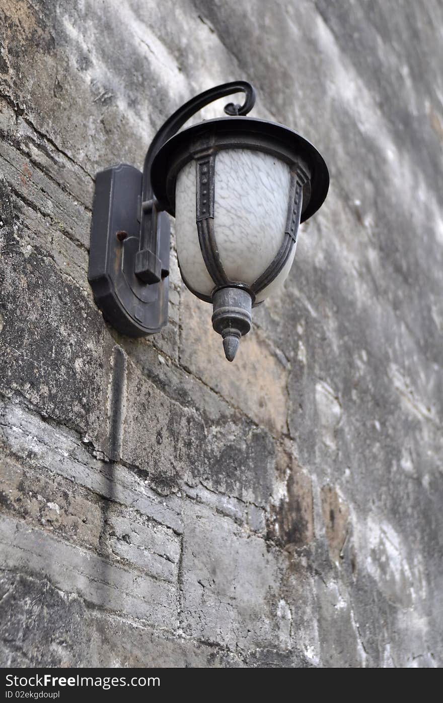 View of old lamp on an old wall