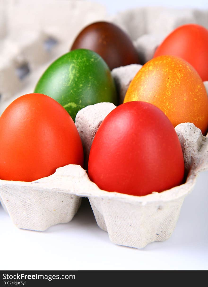 Colorful eggs in a carton