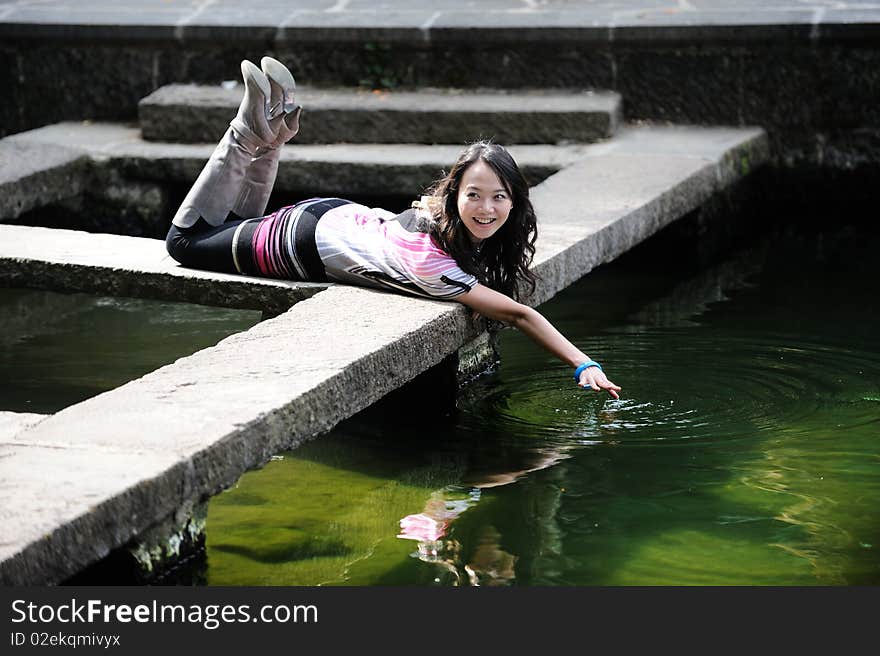 Chinese girl playing by water. Chinese girl playing by water.