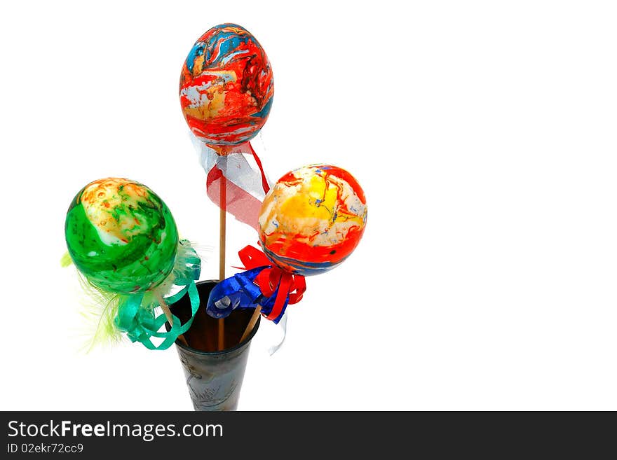 Easter eggs in a glass on a white background