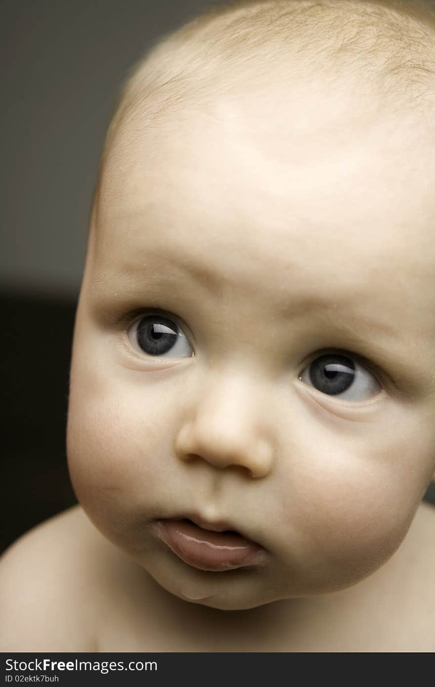 Baby shot in studio not looking into camera. Baby shot in studio not looking into camera