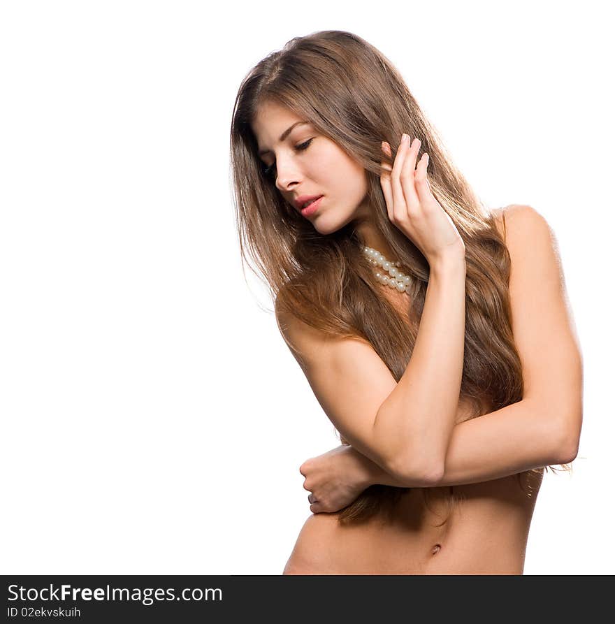 Beautiful blonde with curly hair and a pearl necklace around his neck, covers the chest hand. Beautiful blonde with curly hair and a pearl necklace around his neck, covers the chest hand