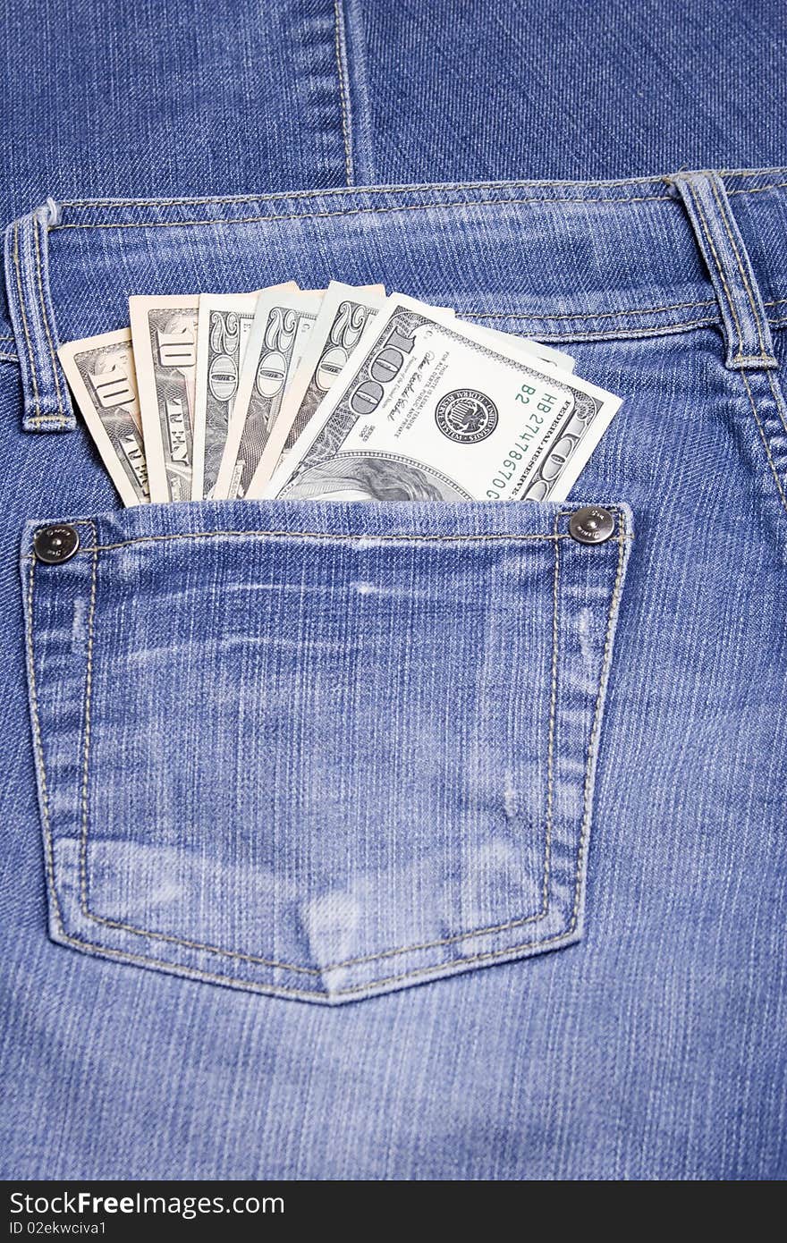 U.S. 100, 20 and 10 dollar bills in his back pocket jeans blue. U.S. 100, 20 and 10 dollar bills in his back pocket jeans blue