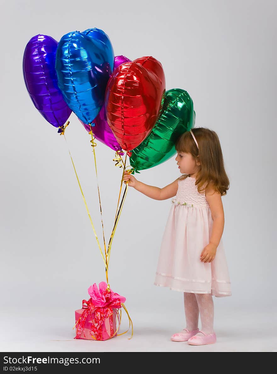 Child in a white dress with balloons. Child in a white dress with balloons