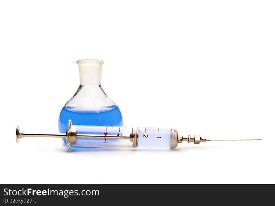 Transparent chemical glassware with blue solution and with syringe isolated on white. Transparent chemical glassware with blue solution and with syringe isolated on white