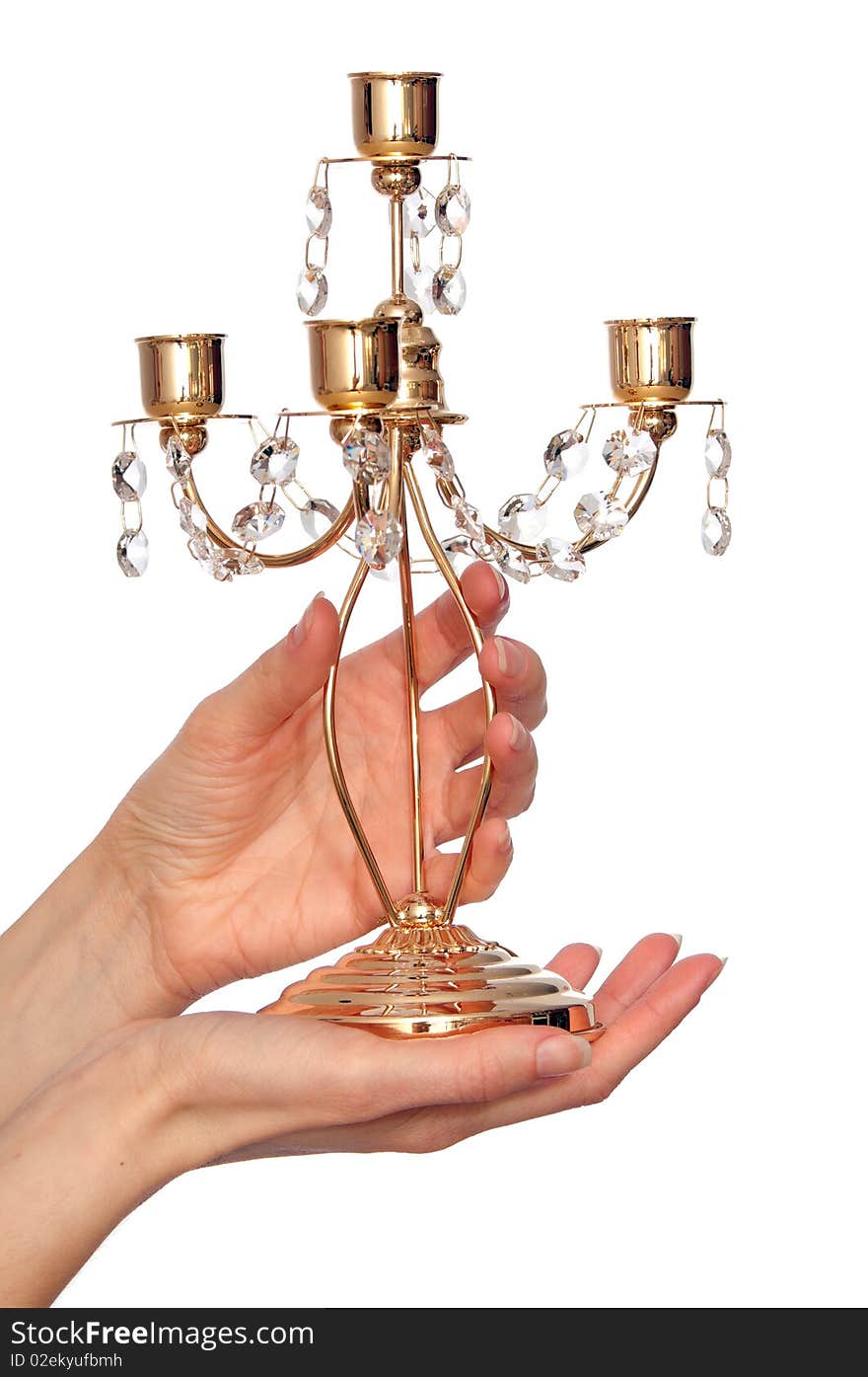 Luxury gold candlestick with precious stones in the woman's hand