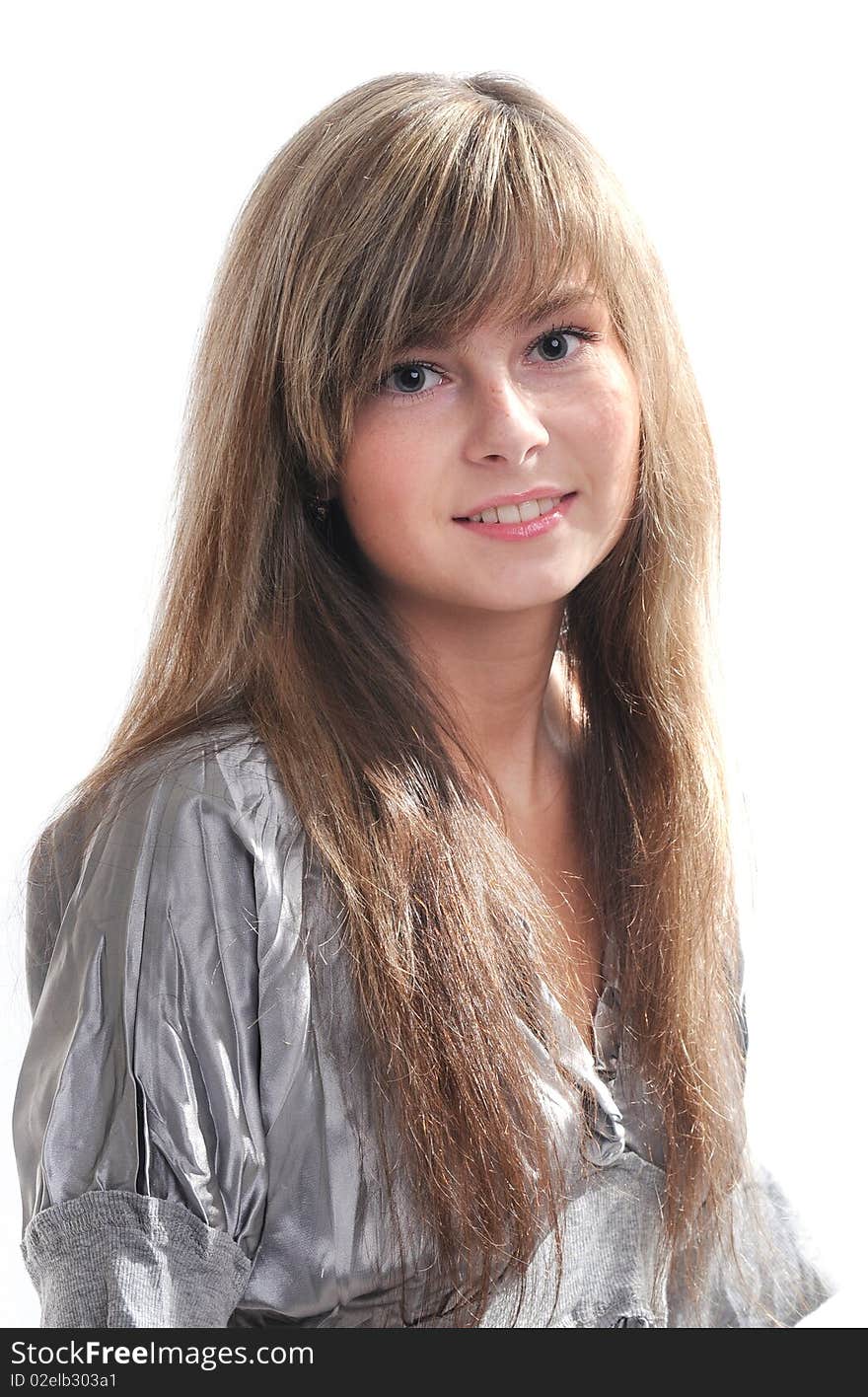 The young beautiful girl with a fair hair in a grey dress separately on a white background