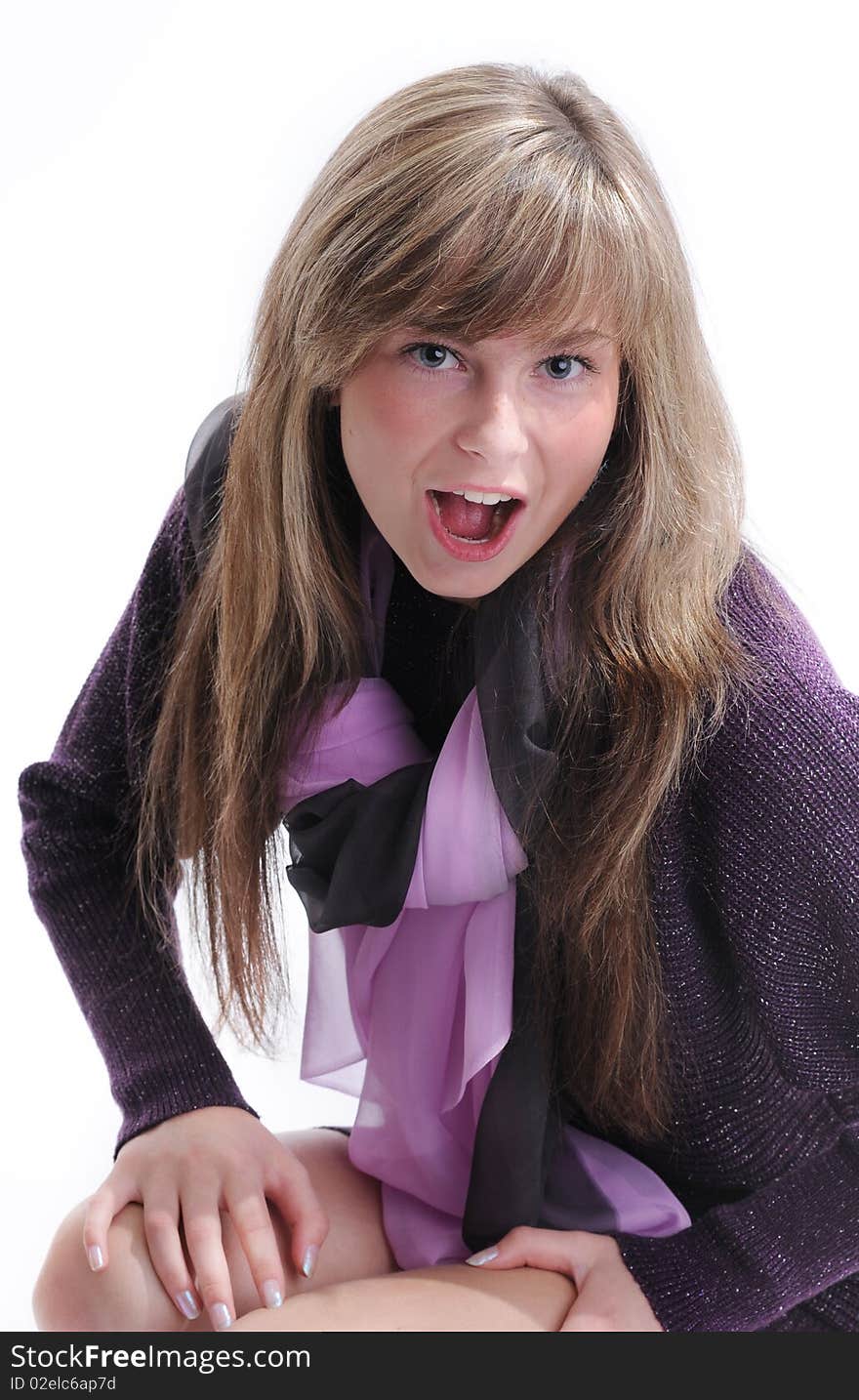 The young beautiful girl with a fair hair in a grey dress separately on a white background