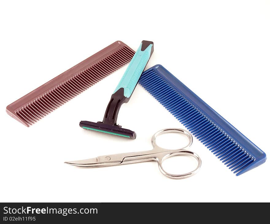 Razor, scissors and combs on the white background.