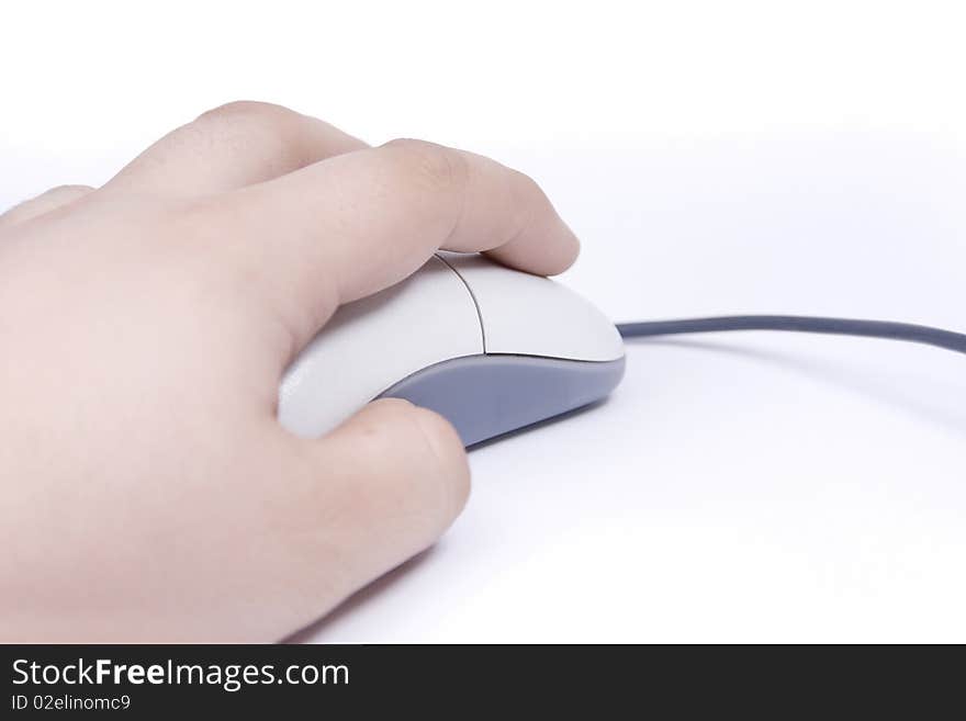 A hand is holding a computer mouse isolated on a white background.