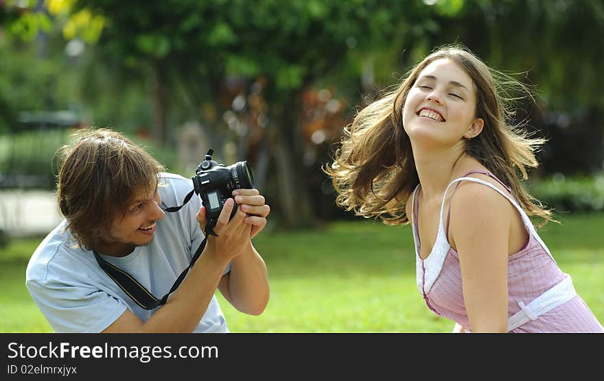 Gorgeous couple take pictures in the park. Gorgeous couple take pictures in the park