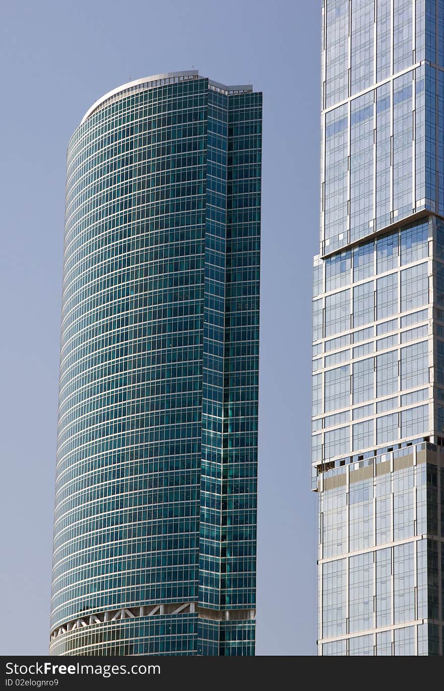 Blue modern office buildings over blue sky