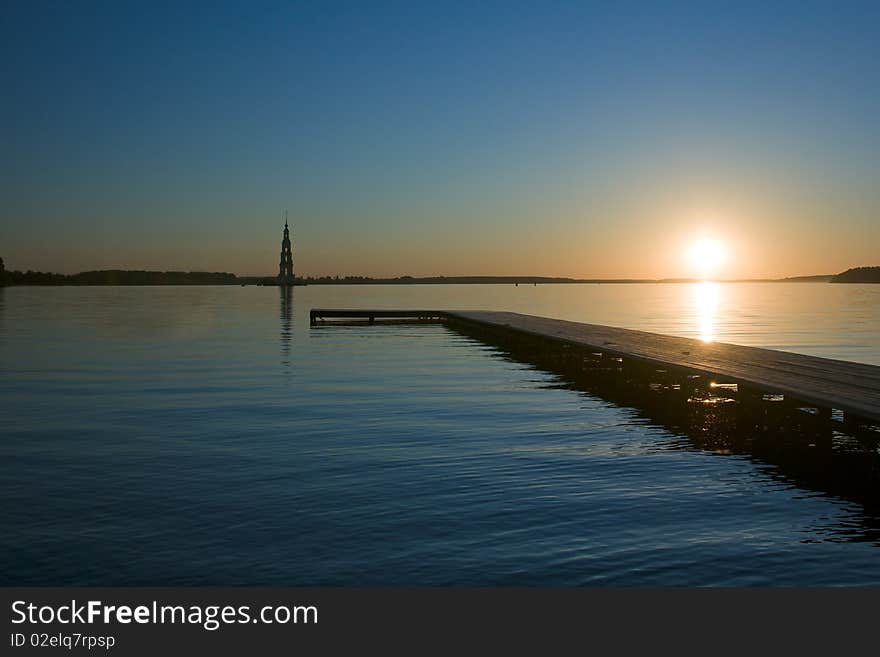 Sunset over Volga river, wooden quay at foreground. Sunset over Volga river, wooden quay at foreground