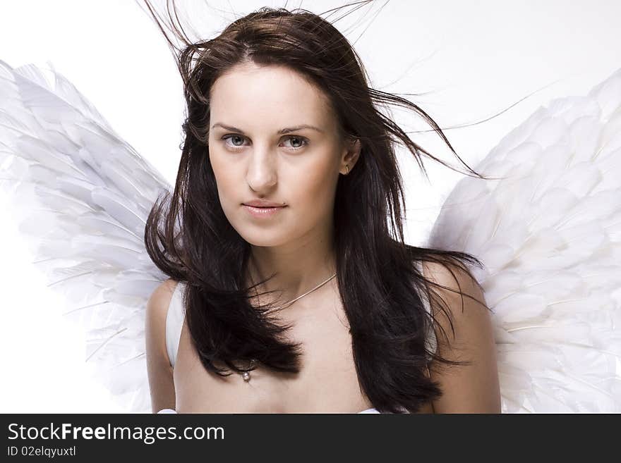 Young  beautiful woman with angel wings and blowing hair. Young  beautiful woman with angel wings and blowing hair