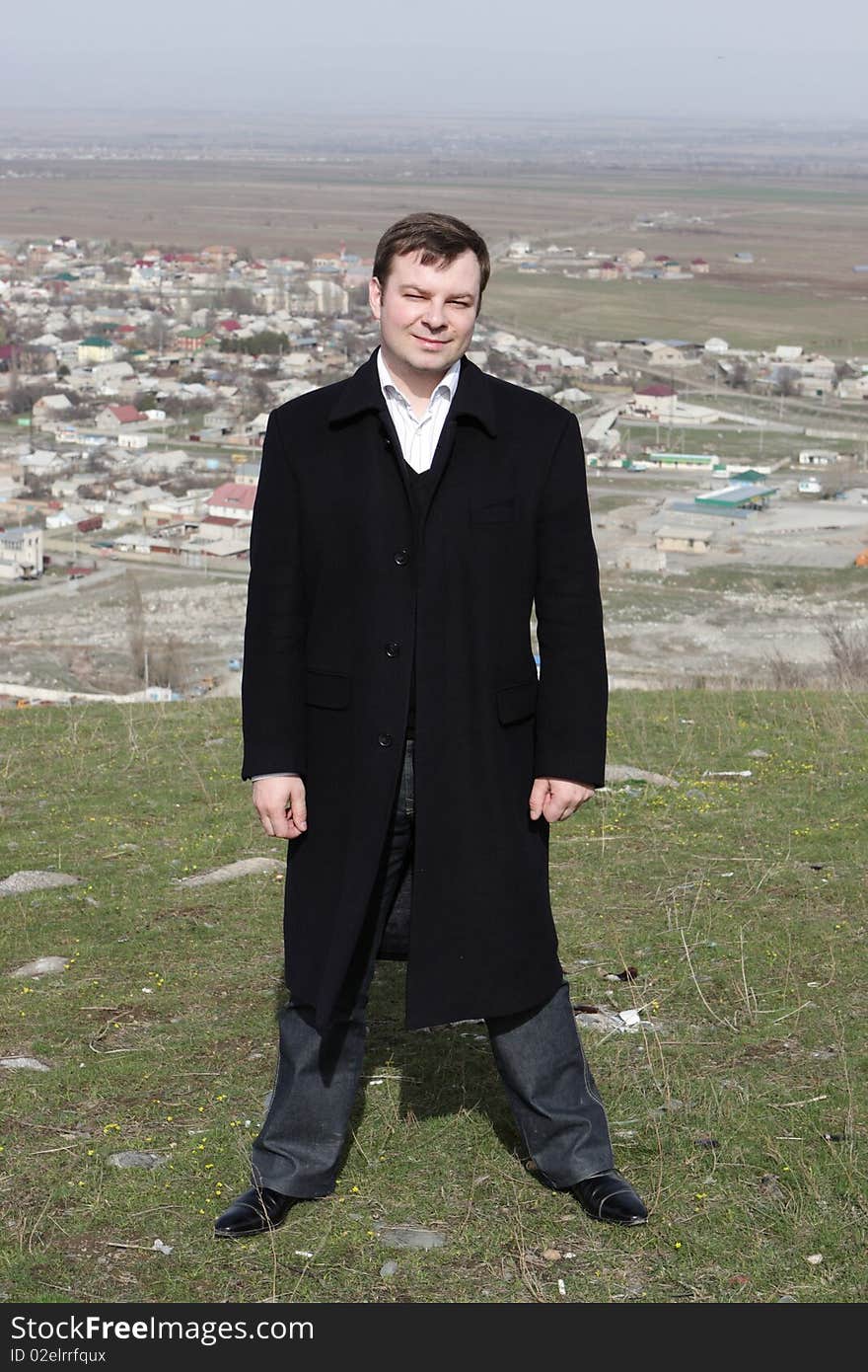 Man poses on Bishkek background