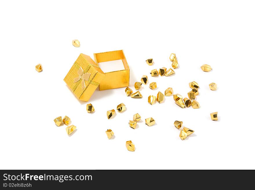 Empty opened golden gift box and golden particles on a white background.