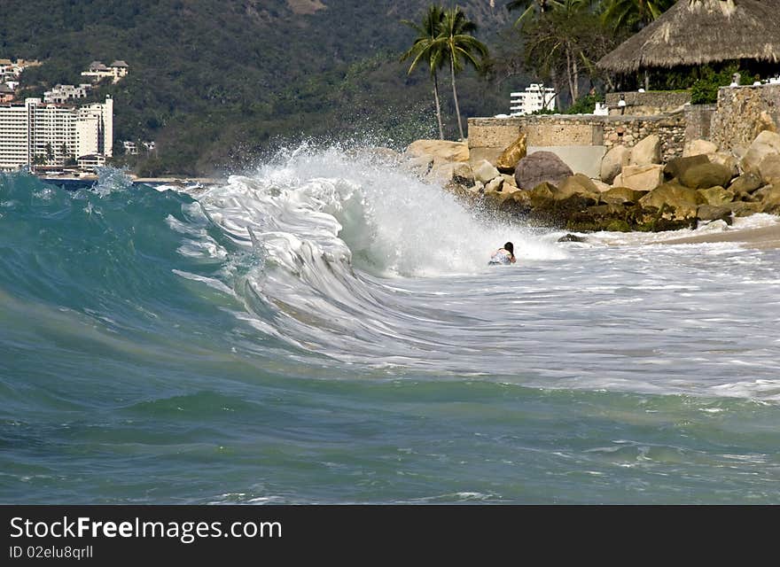 Bather catching high surf