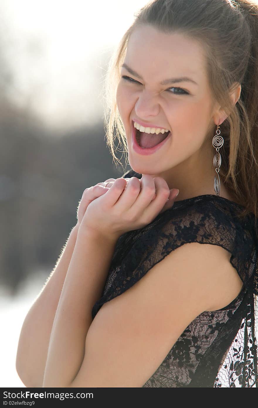 Happy young female smiling while outdoors, close-up portrait