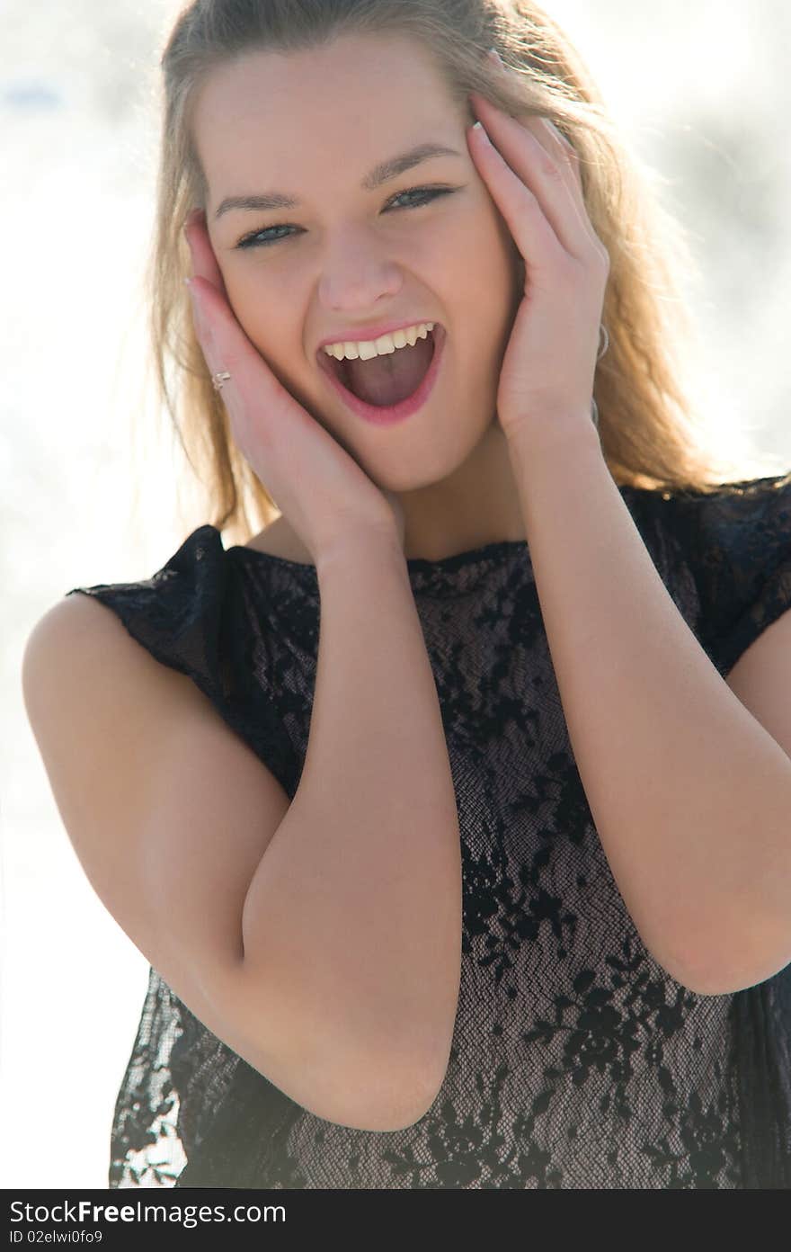 Happy young female smiling while outdoors, close-up portrait