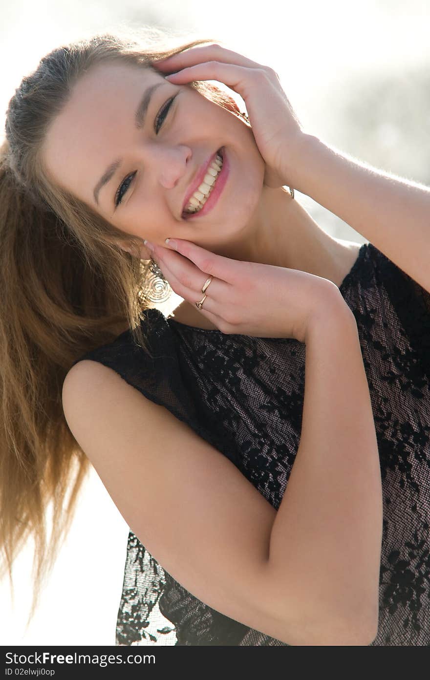 Happy young female smiling while outdoors, close-up portrait