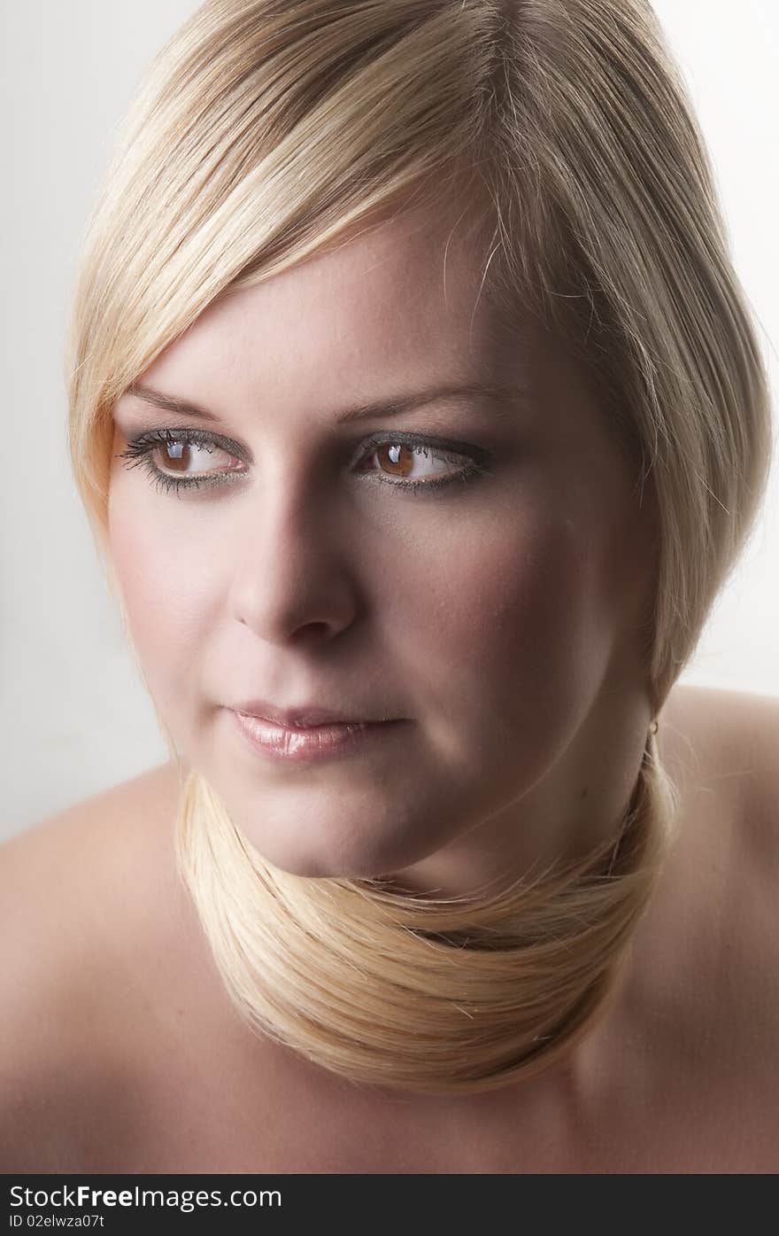 Beauty portrait of a young woman with her hair around neck.