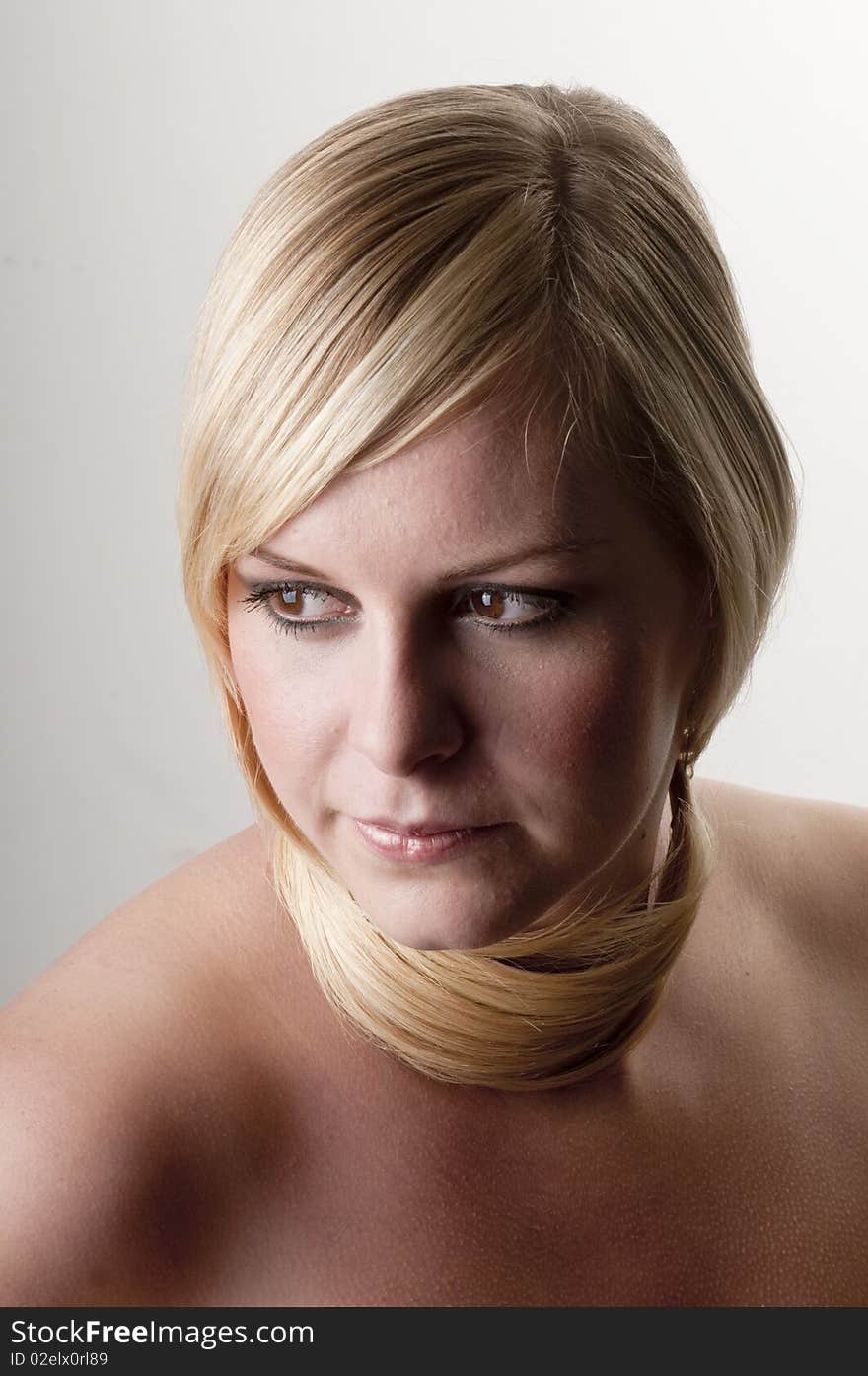 Beauty portrait of a young woman with her hair around neck.