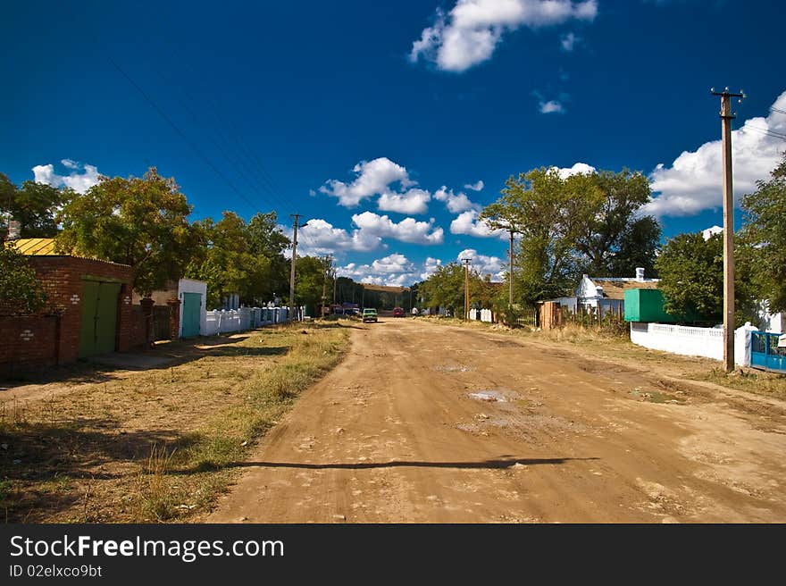 Earthen street in the village in summer