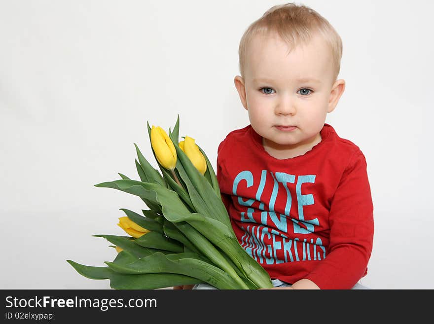 Baby boy with bouquet of flowers. Baby boy with bouquet of flowers