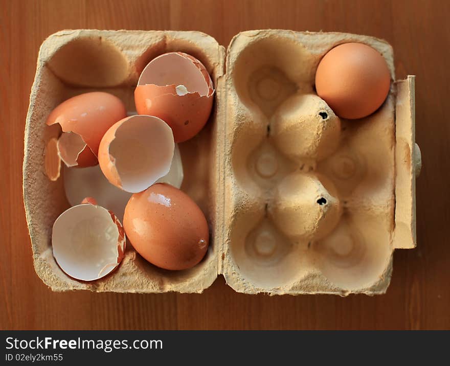 Closeup on eggs in carton with one egg left and the rest used empty. Closeup on eggs in carton with one egg left and the rest used empty