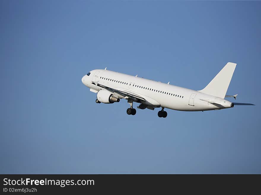 Airliner taking off in a blue sky