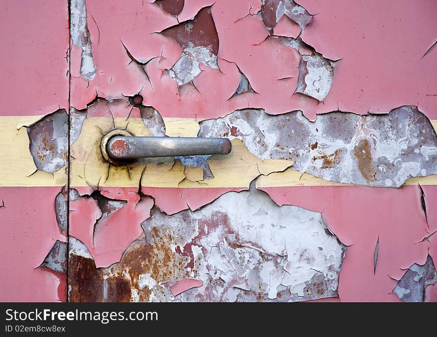 Old red painted steel door texture with metal lever