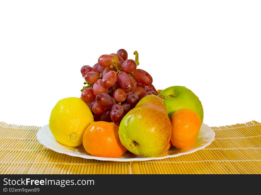 Ripe Fruits In Plate On Table