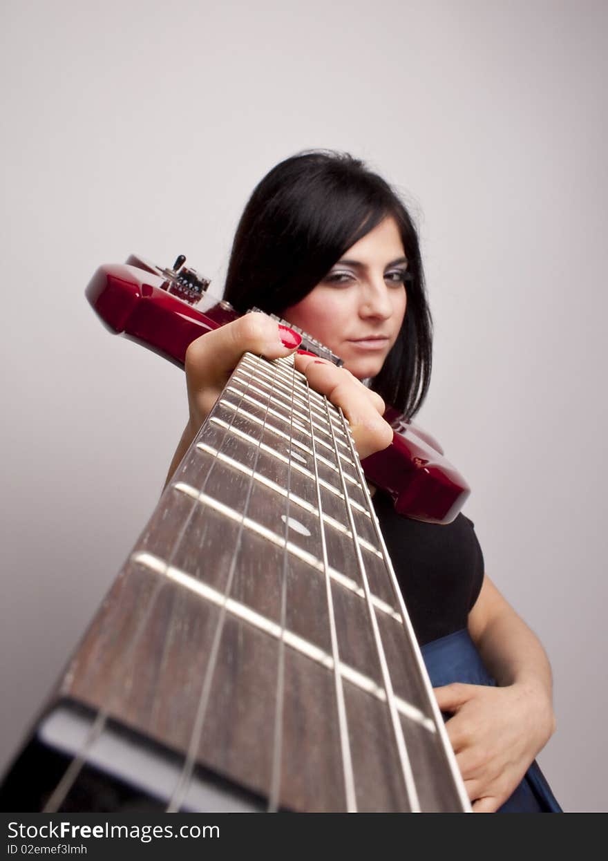 Woman looking down the neck of the  Guitar . Woman looking down the neck of the  Guitar .