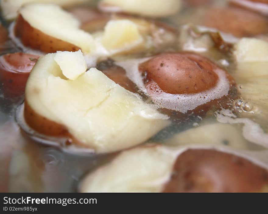 Scrumptious red potatoes simmering in boiling water