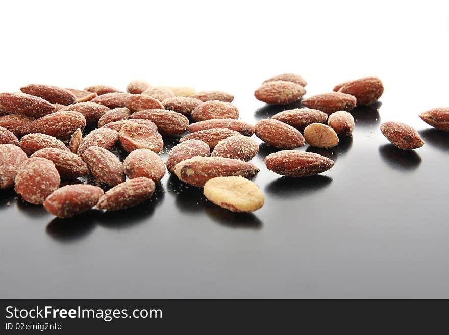 Salty almonds scattered across a table