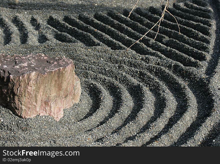 Detail of a Zen garden in Kyoto. The gravel has been raked by monks and helps them get into the moment. This Zen garden is made up of rocks and gravel. Detail of a Zen garden in Kyoto. The gravel has been raked by monks and helps them get into the moment. This Zen garden is made up of rocks and gravel.