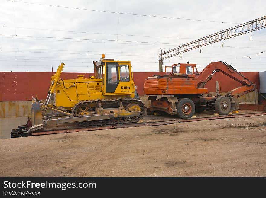 The heavy building bulldozer on rayl platform. The heavy building bulldozer on rayl platform