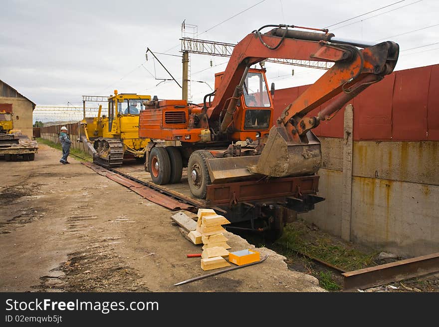 The heavy building bulldozer on rayl platform. The heavy building bulldozer on rayl platform