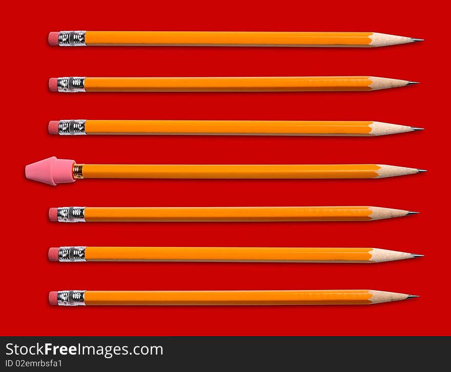 Yellow pencils with two different kinds of erasers isolated over red. Yellow pencils with two different kinds of erasers isolated over red