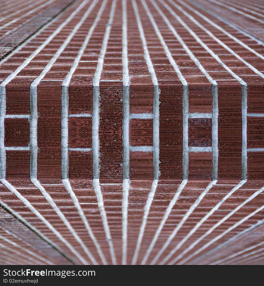 An abstract angle of a brick wall corner with clean red new red bricks. An abstract angle of a brick wall corner with clean red new red bricks