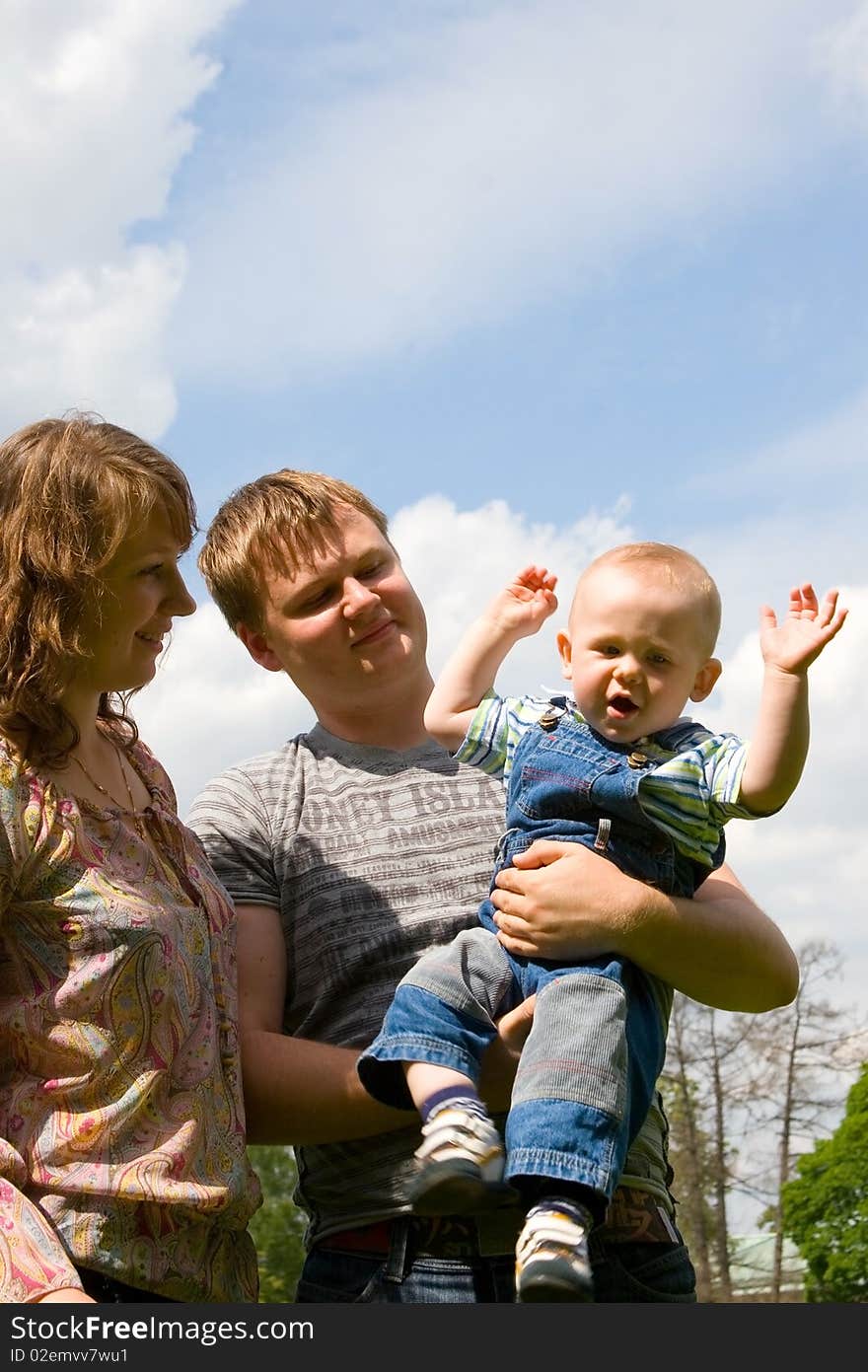 Happy family with son walking outdoors