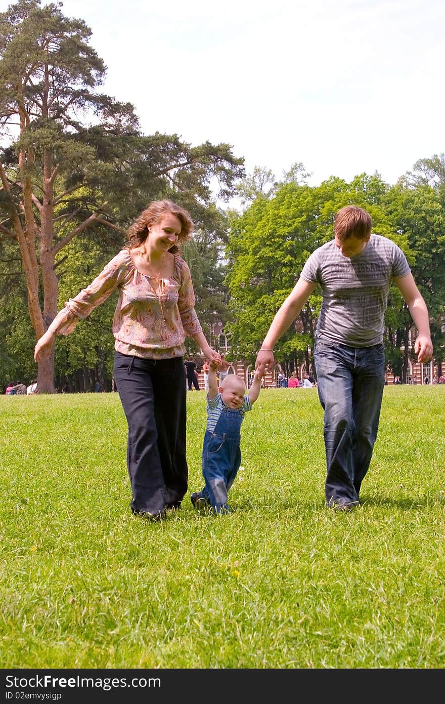 Happy family with son walking outdoors