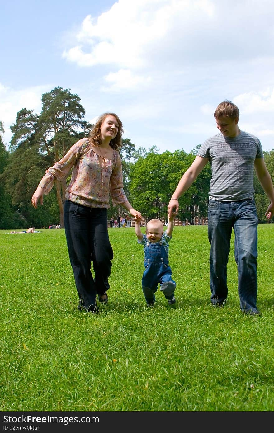 Happy family with son walking outdoors