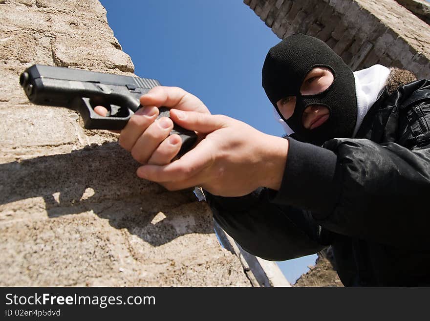 Armed Criminal Aiming With A Pistol