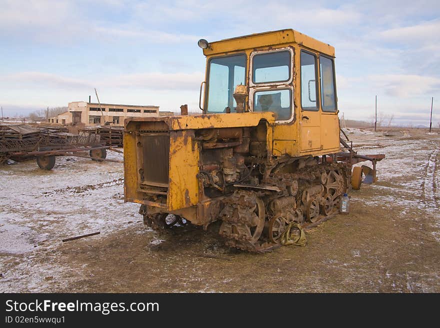 The yellow heavy building bulldozer,tractor in field. The yellow heavy building bulldozer,tractor in field