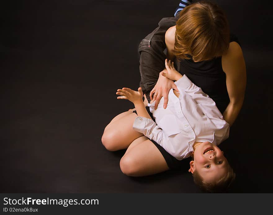 Portrait of a family - mother holding her little son and tickling him, he is laughing. Portrait of a family - mother holding her little son and tickling him, he is laughing