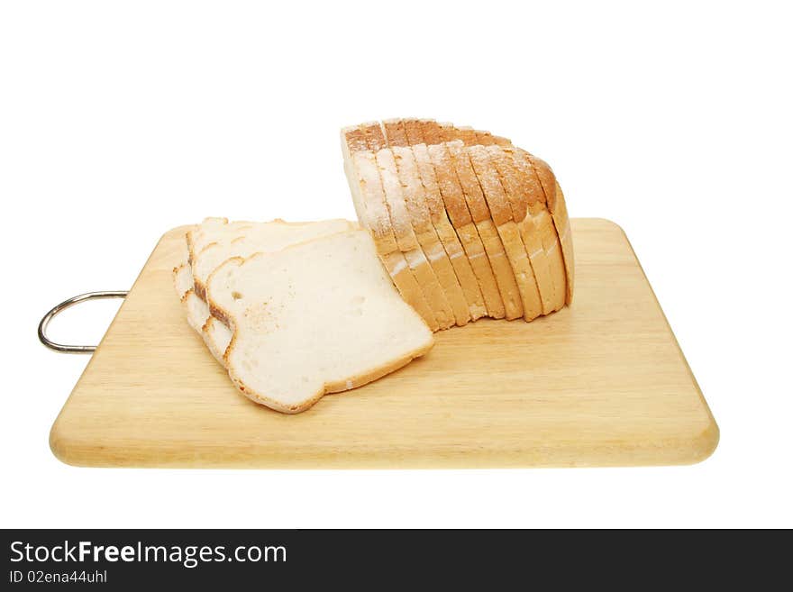 Loaf of sliced crusty white bread on a board. Loaf of sliced crusty white bread on a board